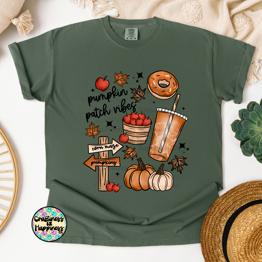 Green t-shirt with autumn-themed graphics on a white background