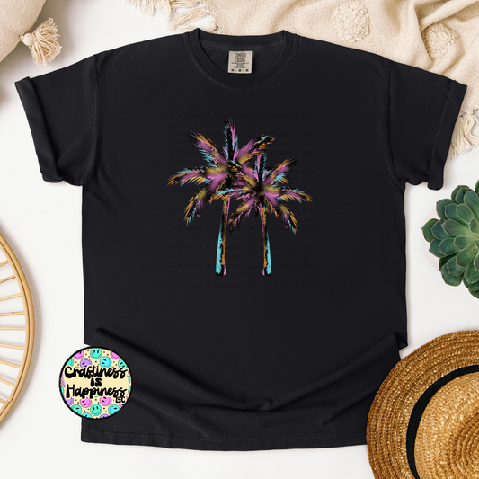 Black t-shirt with colorful palm tree design on a textured surface