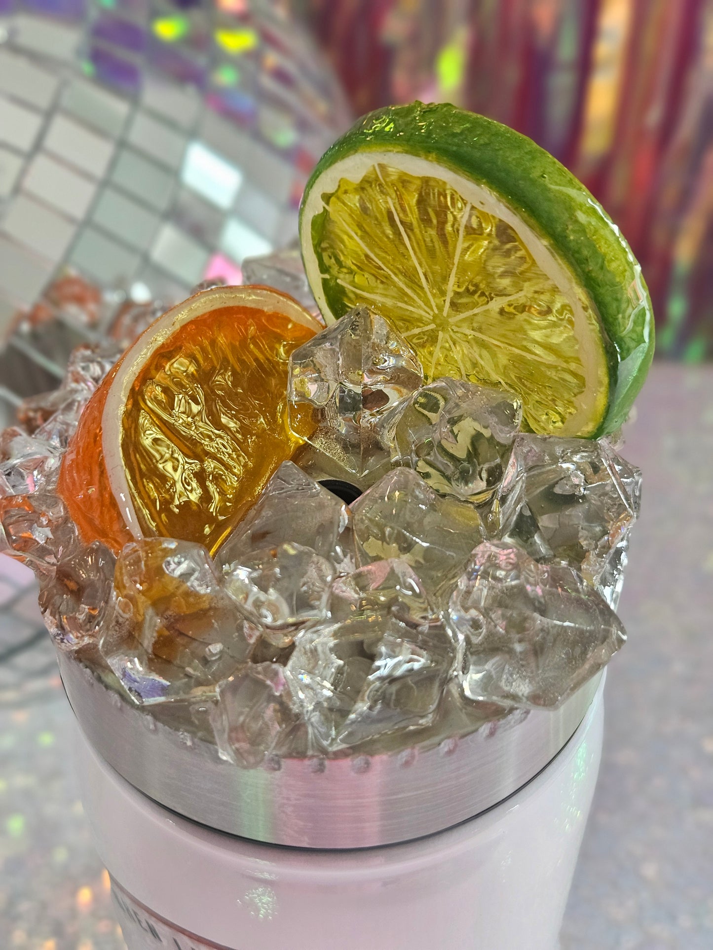 Stainless Steel screw on topper, decorated with faux ice and a slice of a lime and an orange. It is sealed with epoxy. 