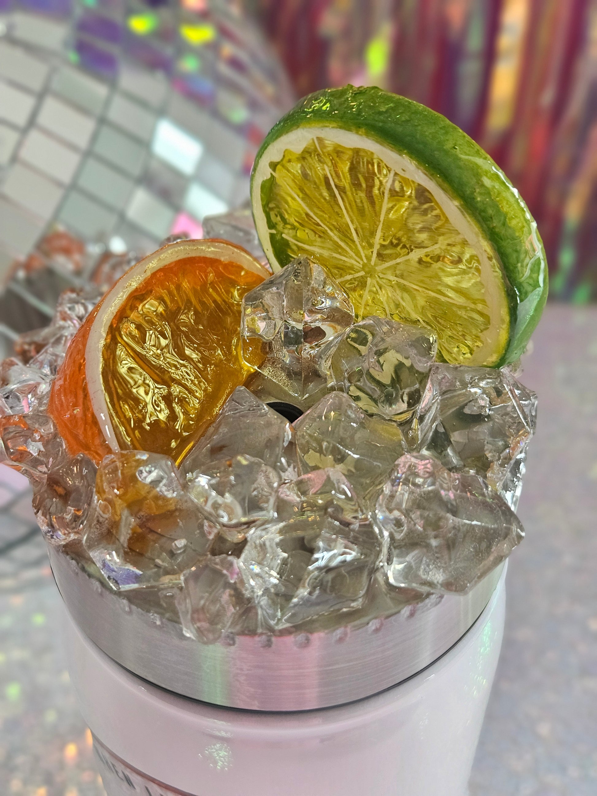 Stainless Steel screw on topper, decorated with faux ice and a slice of a lime and an orange. It is sealed with epoxy. 