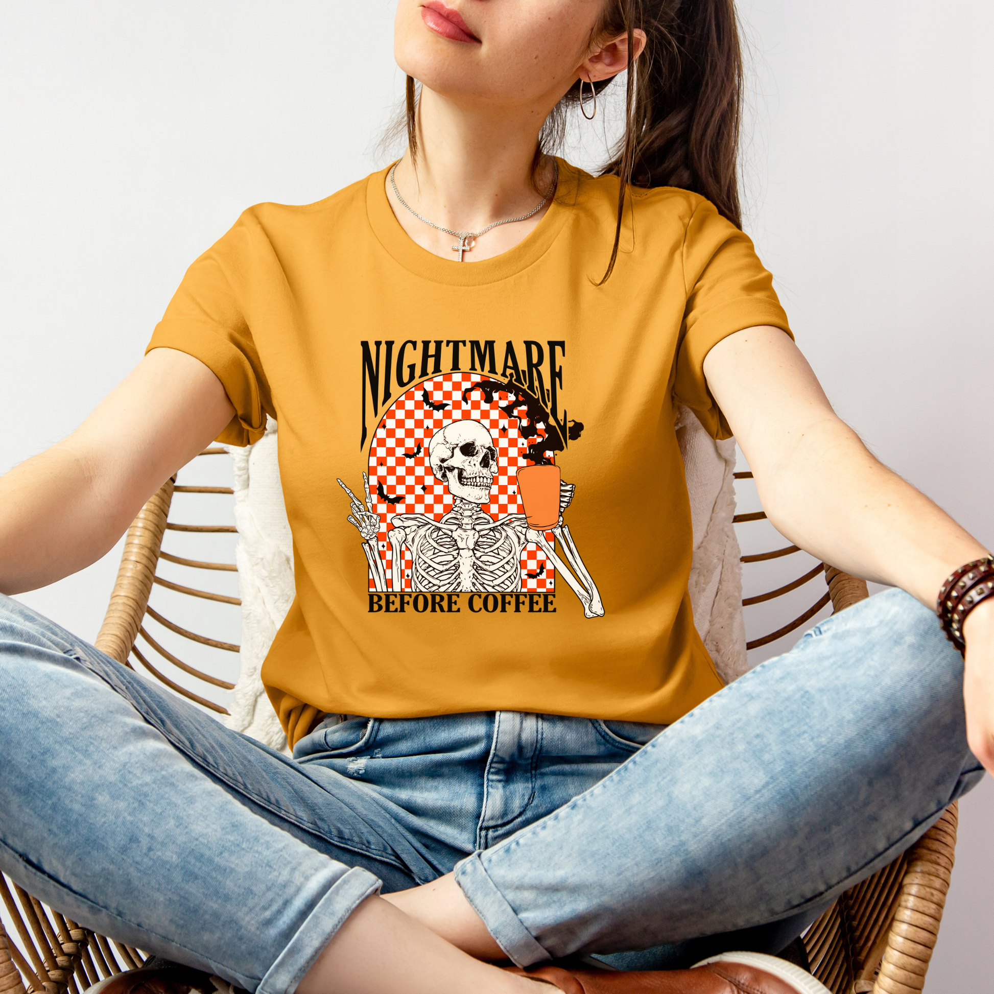 Mustard short sleeve t-shirt "Nightmare Before Coffee"  saying, a retro orange & white checkerboard background with a skeleton holding a cup of coffee-front