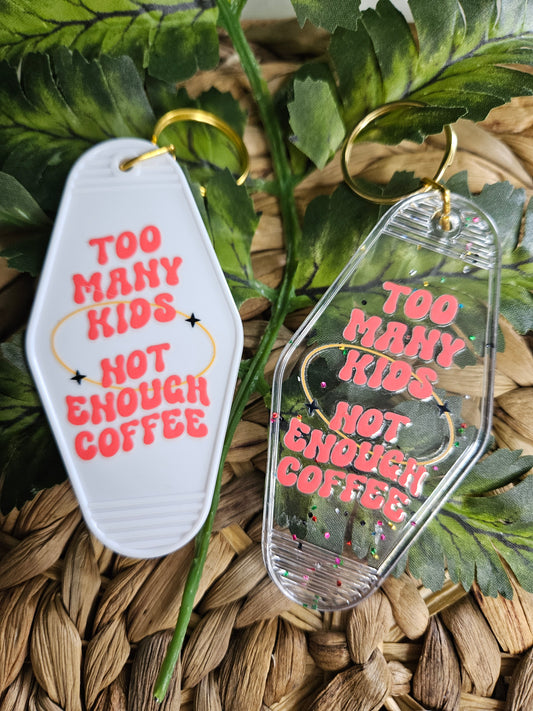 Available in a plain white or clear acrylic motel/ retro style keychain with confetti speckles. Decorated with a coral UV DTF Decal" Too many kids, not enough coffee. Both keychain color options have gold hardware.