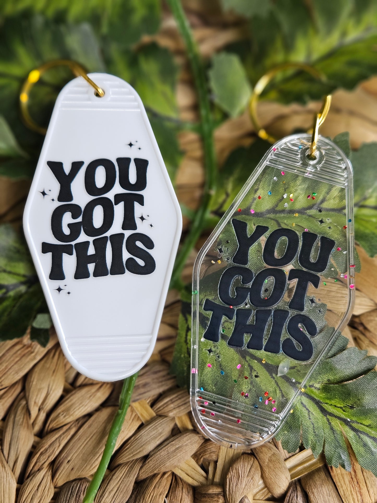 Available in a plain white or clear acrylic motel/ retro style keychain with confetti speckles. Decorated with a black wavy retro font, UV DTF Decal" You Got This". White and clear keychains have a gold colored hardware.